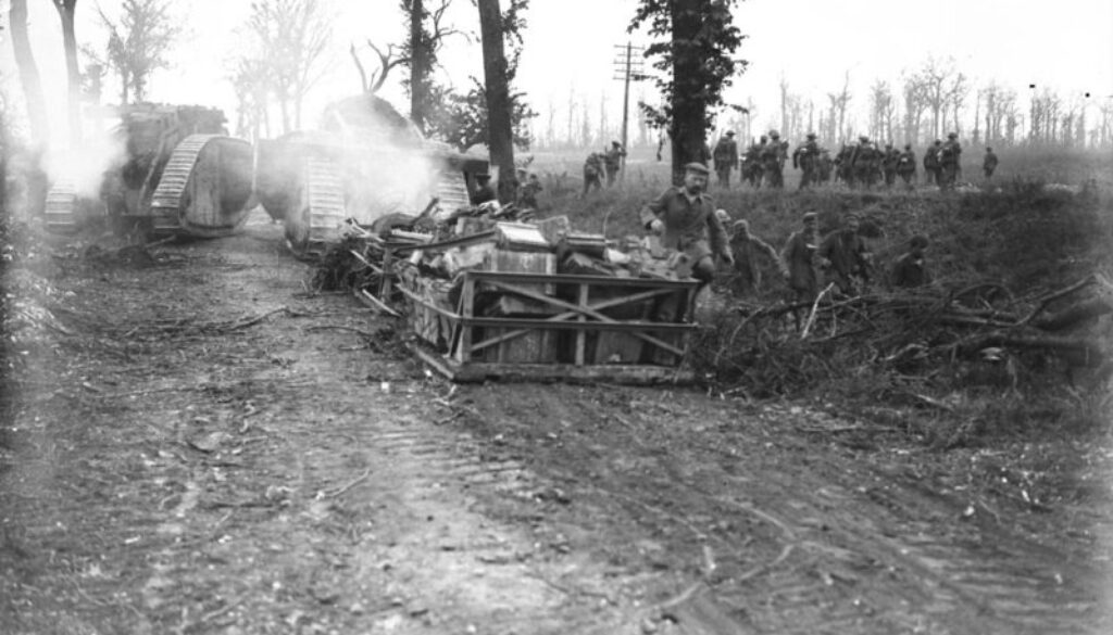 29_Tanks going forward to attack Germans in wood, Infantry on right; prisoners are seen coming in
